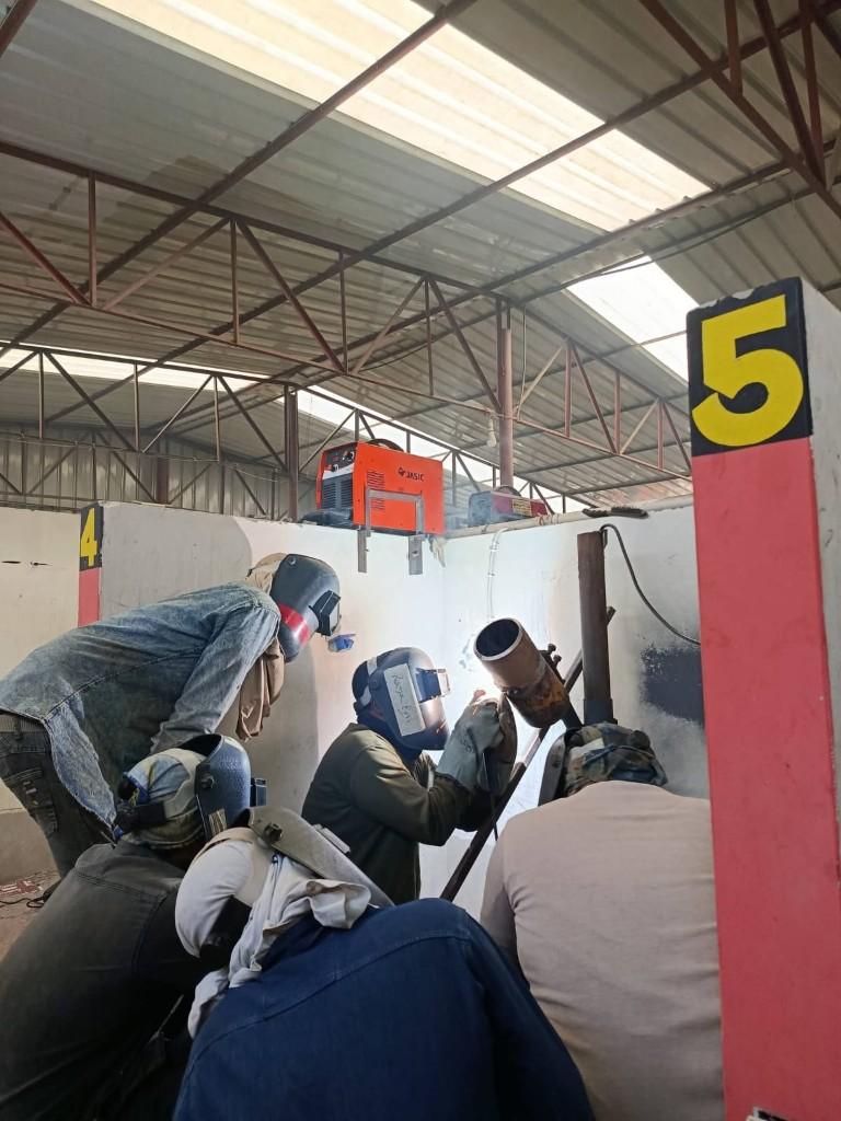 Students at welding booths
