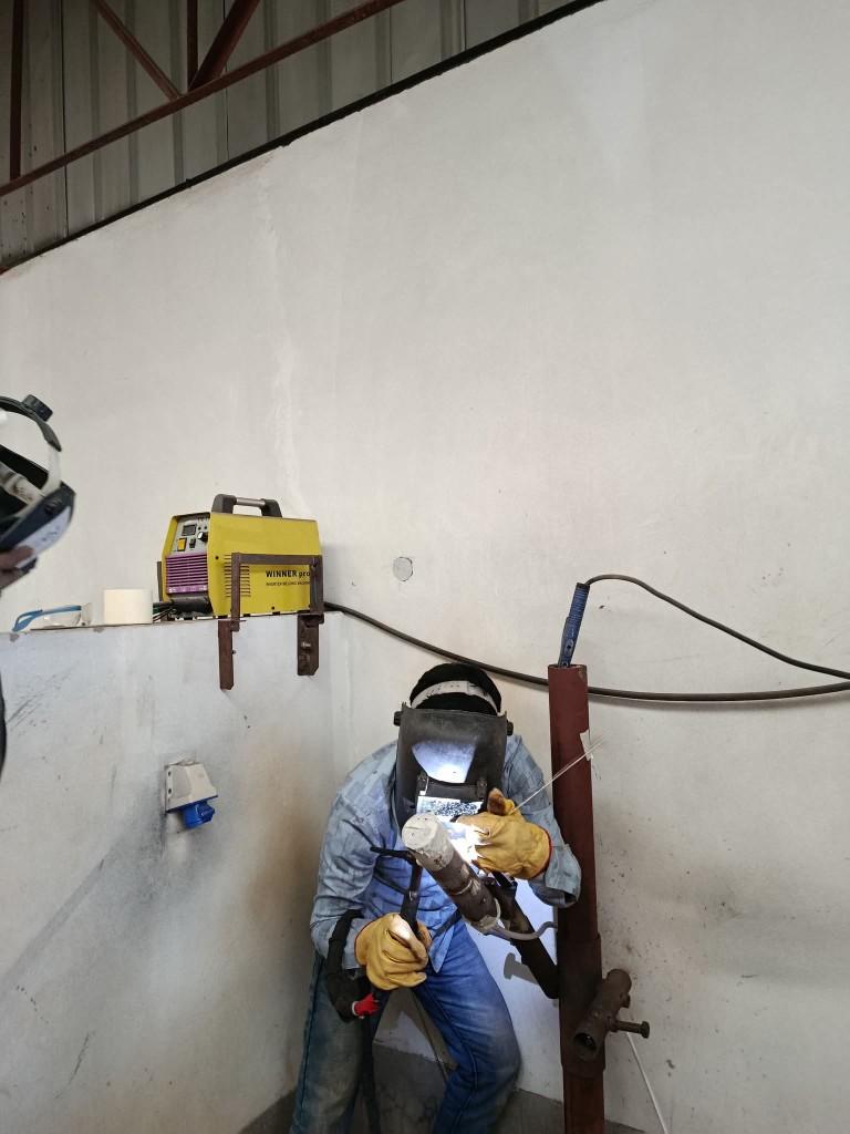 Student welding pipe